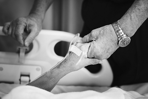 Photograph of patient holding hands with relative