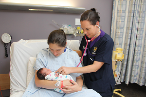 Photograph of nurse with patient and baby