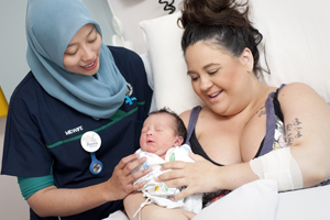 Midwife with mum and baby