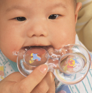 Baby sucking on teething ring